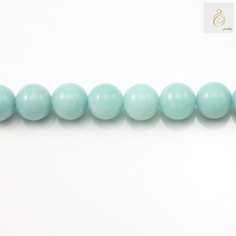 Natural amazonite round beads 12mm on white backgroundClose-up of amazonite gemstone beads showing blue-green color and smooth finish