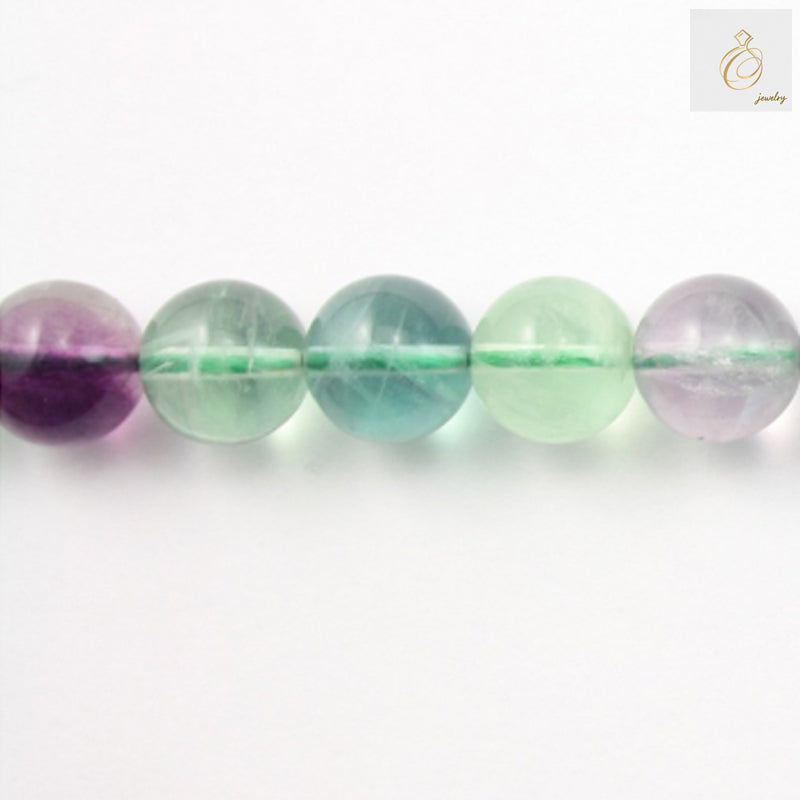 Natural fluorite round beads 12mm diameter on white background"
"Close-up of translucent fluorite gemstone beads showing natural color variations"
"39cm strand of purple fluorite round beads for jewelry making