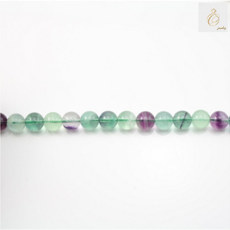 Natural fluorite round beads 4mm diameter on 39cm strand for jewelry making""Close-up view of natural fluorite round beads showing 4mm size and 0.8mm holes"