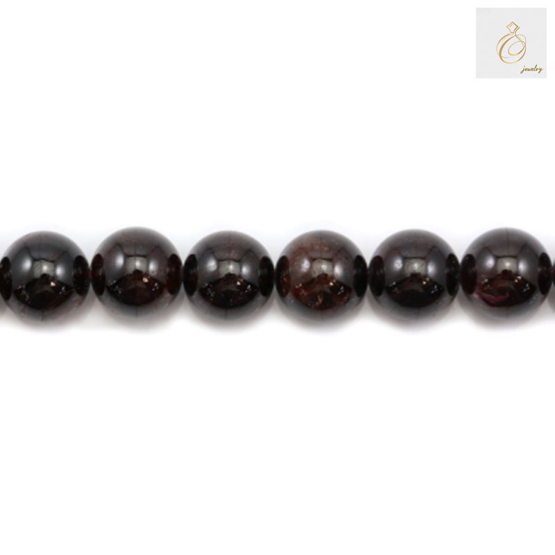 Close-up view of natural garnet beads showing deep red color and smooth round shape