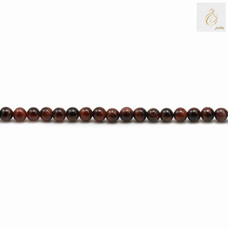 Close-up view of natural red tiger's eye beads showing the beautiful chatoyancy and rich red color variations, 3mm diameter round beads