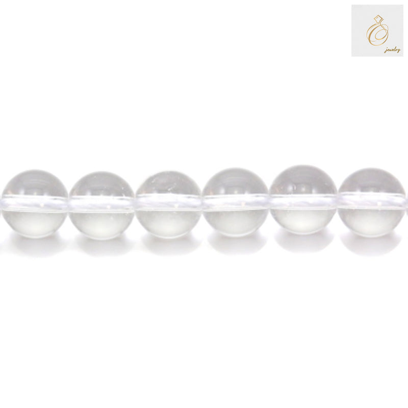 Close-up view of natural rock crystal beads displaying the transparent clarity and round shape of 10mm gemstone beads for DIY jewelry projects