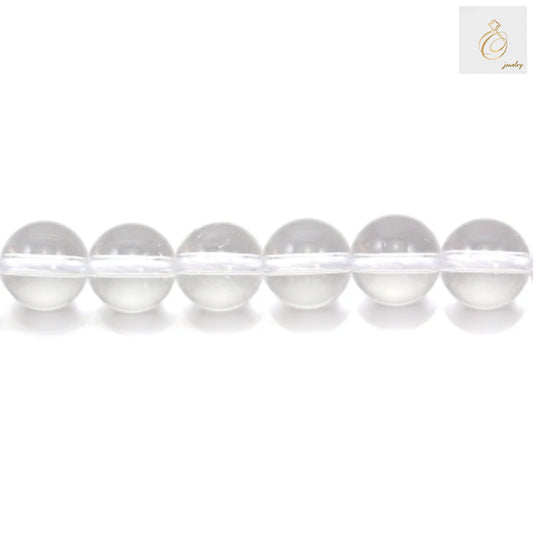 Close-up view of natural rock crystal beads showing clarity and round shape, 6mm diameter jewelry making supplies