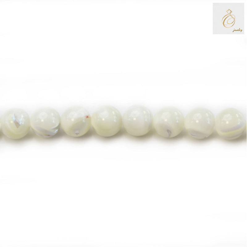 Natural white mother-of-pearl round beads 8mm diameter arranged in strand showing lustrous surface and uniform size
