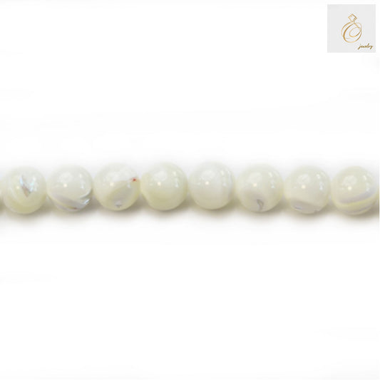 Natural white mother-of-pearl round beads 8mm diameter arranged in strand showing lustrous surface and uniform size