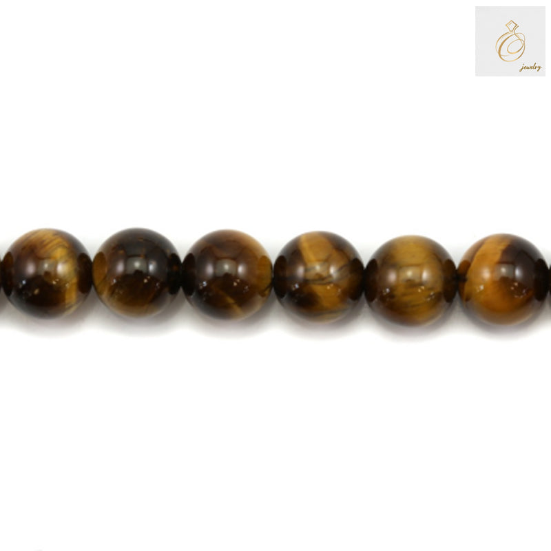 Close-up view of natural yellow tiger's eye round beads displaying the characteristic golden-brown striped pattern
