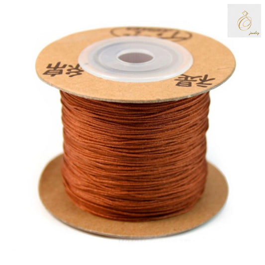 Caramel colored polyester jewelry thread spool 0.5mm diameter"
"Premium polyester thread for jewelry making in caramel color"
"180 meter spool of 0.5mm caramel polyester crafting thread