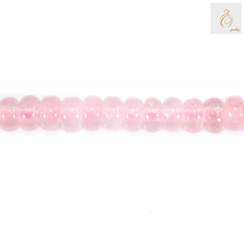 Close-up view of rose quartz heishi disc beads showing natural pink color and smooth finish