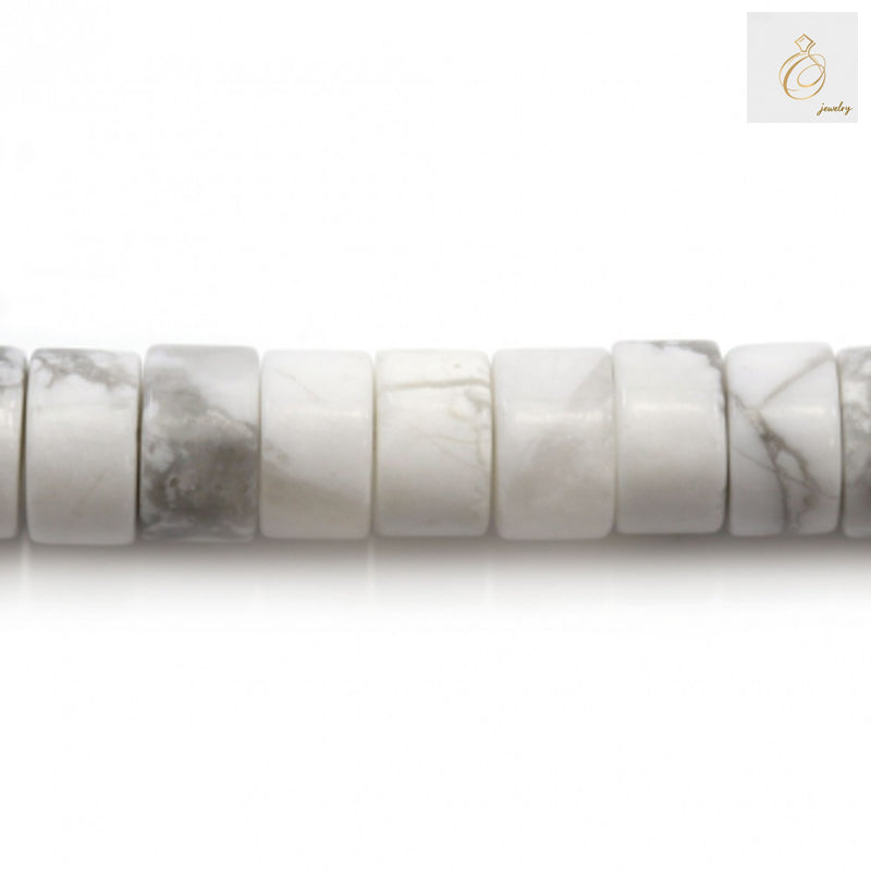 Close-up of white howlite gemstone beads showing 2x4mm heishi shape and texture