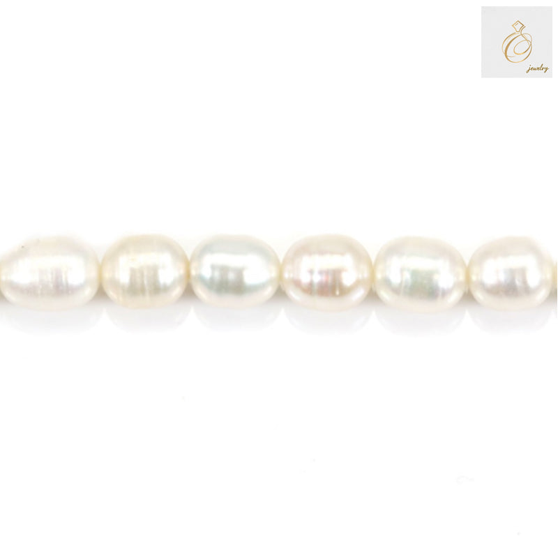 Close-up view of white freshwater cultured pearls showing lustrous surface and oval shape, 6-7mm size