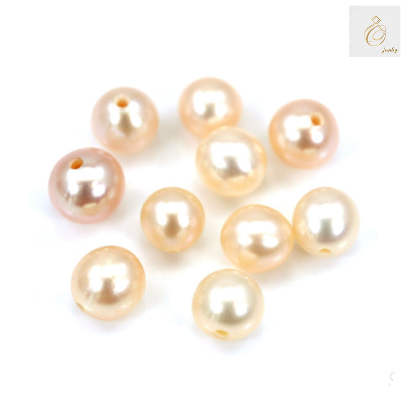 Close-up view of champagne freshwater cultured pearl beads showing lustrous surface and round shape, half-drilled for jewelry crafting