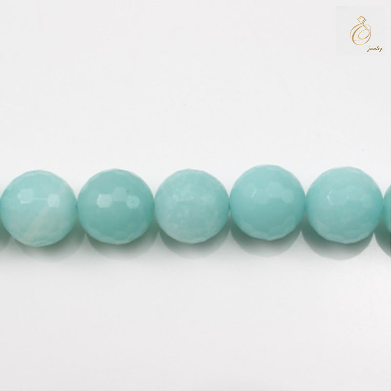 Natural amazonite faceted round beads 6mm diameter on white backgroundClose-up view of blue-green amazonite gemstone beads showing faceted surface and clarity