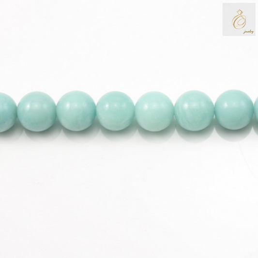 Natural amazonite round beads 12mm on white backgroundClose-up of amazonite gemstone beads showing blue-green color and smooth finish
