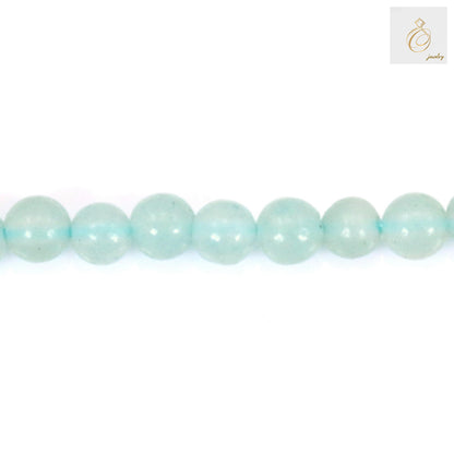 Amazonite beads jewelry making scene with 2mm round beads, crafting tools, and partially completed bracelet on wooden table