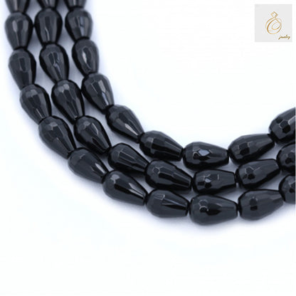 Black agate faceted teardrop beads arranged in multiple strands showing the elegant 6x9mm size and lustrous black finish