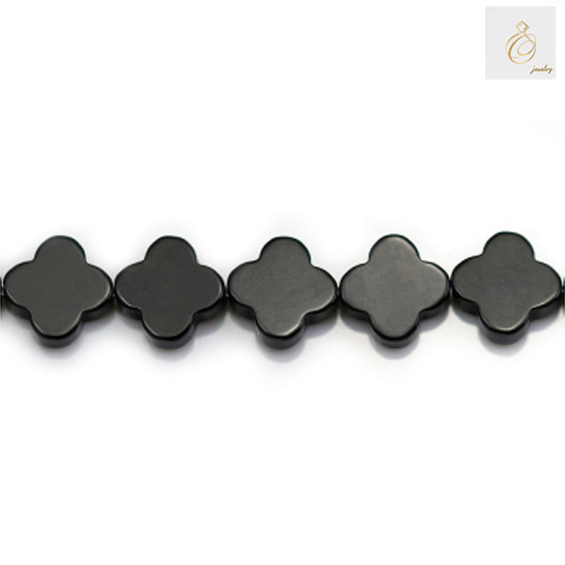 Close-up view of 10mm black agate clover beads showing natural stone texture and shine 