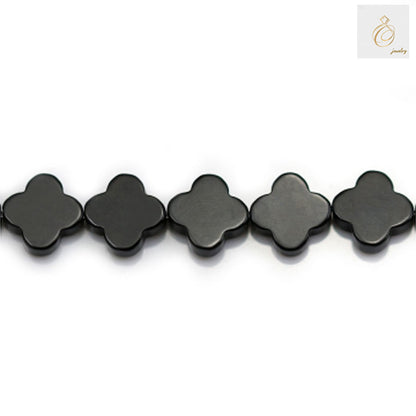 Close-up view of 10mm black agate clover beads showing natural stone texture and shine 