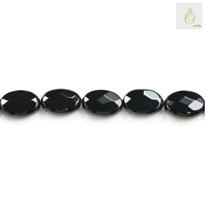 Black agate faceted oval beads 10x14mm arranged in a strand showing consistent size and quality for crafting projects
