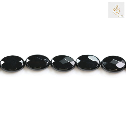 Black agate faceted oval beads 10x14mm arranged in a strand showing consistent size and quality for crafting projects