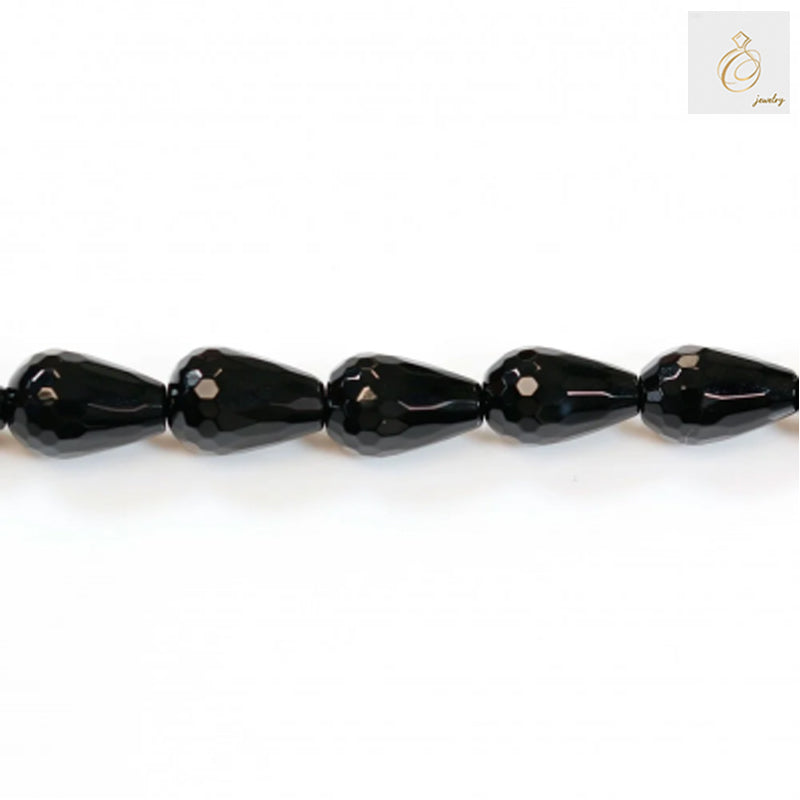 Close-up view of black agate faceted teardrop beads 8x12mm displaying the precise cut and lustrous surface quality
