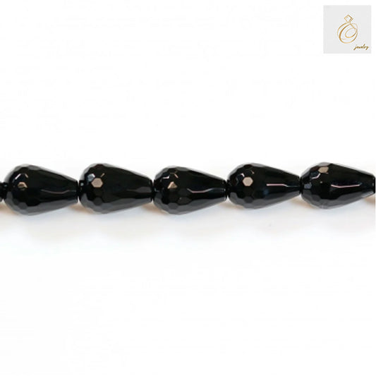 Close-up view of black agate faceted teardrop beads 8x12mm displaying the precise cut and lustrous surface quality