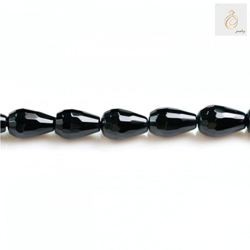 Close-up view of black agate faceted teardrop beads in a single strand highlighting the precise faceting and glossy surface