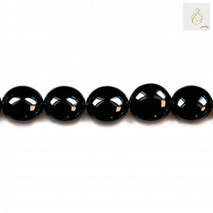Black Agate Flat Round Gemstone Strand - 12mm beads in a row displaying high polish and uniform shape