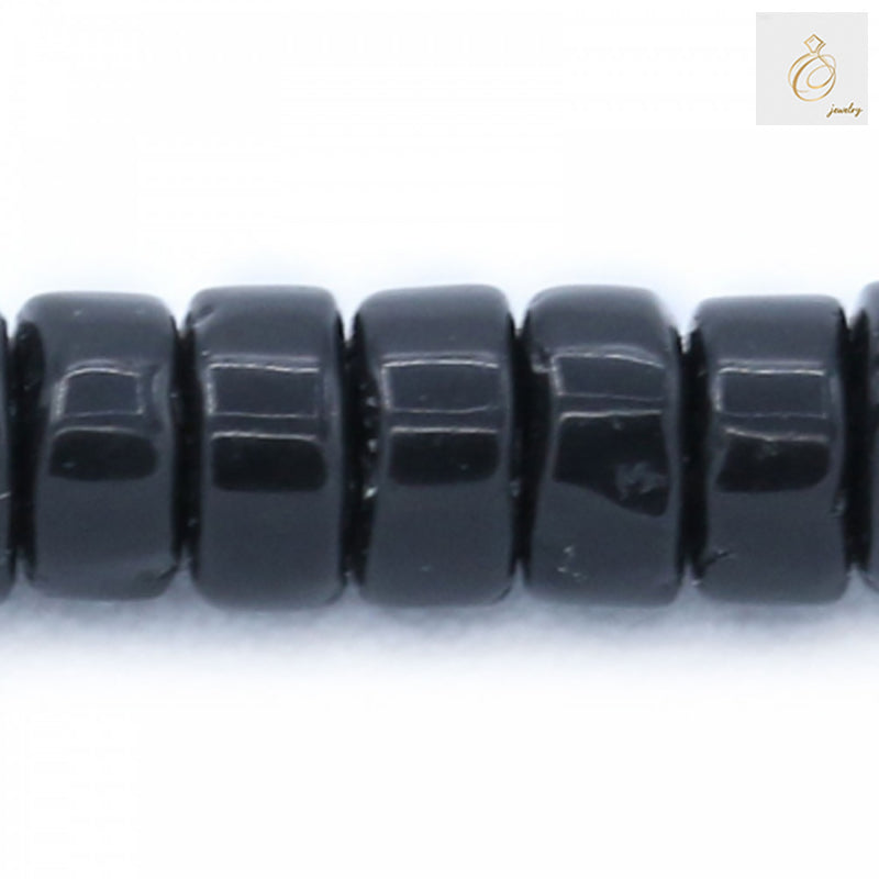 Close-up detail of Black Agate Heishi beads 2x4mm showing the smooth polished surface and precise cylindrical cut of individual beads
