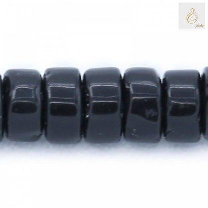 Close-up detail of Black Agate Heishi beads 2x4mm showing the smooth polished surface and precise cylindrical cut of individual beads