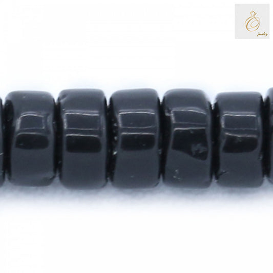 Close-up detail of Black Agate Heishi beads 2x4mm showing the smooth polished surface and precise cylindrical cut of individual beads