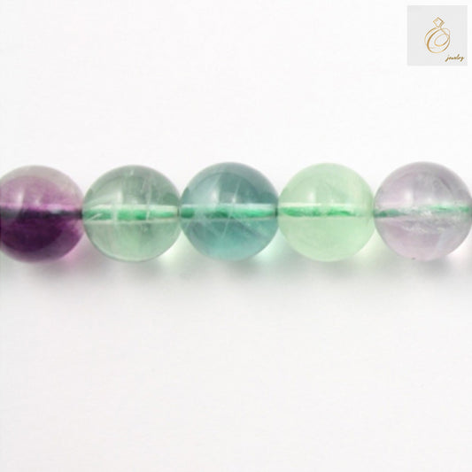 Natural fluorite round beads 12mm diameter on white background"
"Close-up of translucent fluorite gemstone beads showing natural color variations"
"39cm strand of purple fluorite round beads for jewelry making