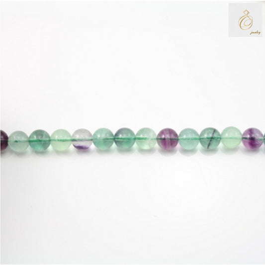 Natural fluorite round beads 4mm diameter on 39cm strand for jewelry making""Close-up view of natural fluorite round beads showing 4mm size and 0.8mm holes"