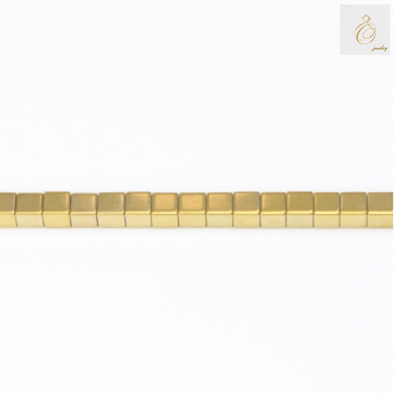 Golden hematite cube beads 3mm with 0.8mm holes arranged on 39-40cm strand, showing lustrous golden metallic finish and precise geometric cube shape