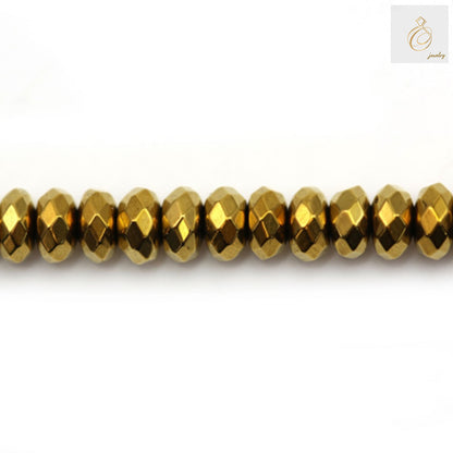 Golden hematite faceted abacus beads 2x4mm arranged on strand showing metallic luster and uniform shape