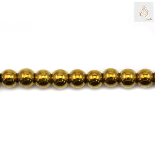 Golden hematite round beads 3mm diameter with metallic finish on white background