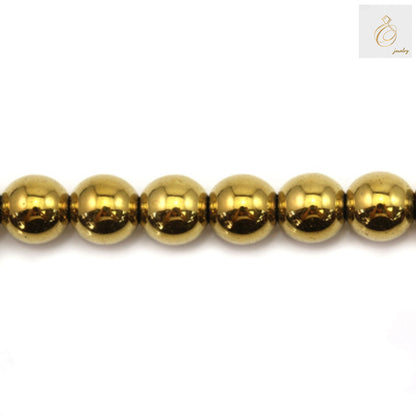 Golden hematite round beads 6mm diameter with metallic luster on white background