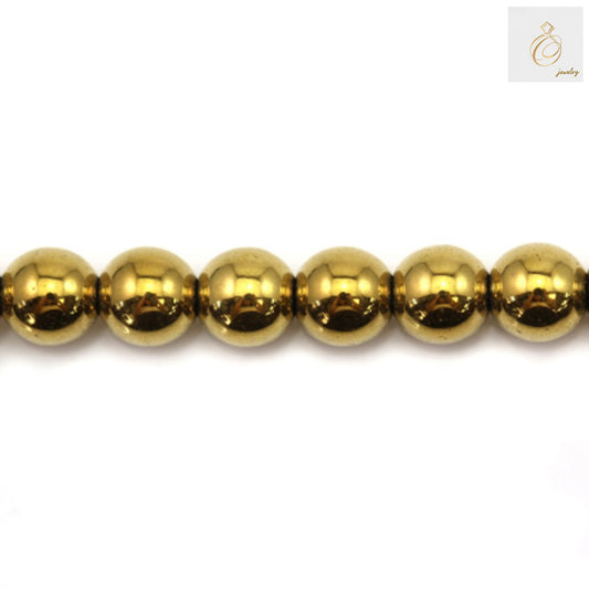 Golden hematite round beads 6mm diameter with metallic luster on white background
