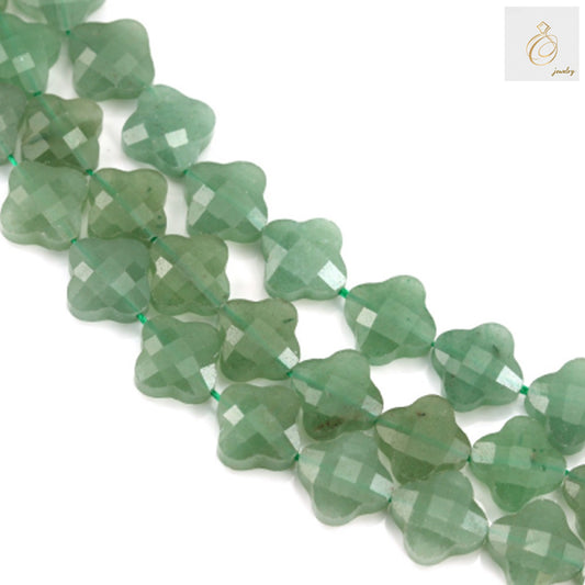 Green aventurine faceted clover beads 13mm arranged on white background showing natural gemstone texture and clover shape