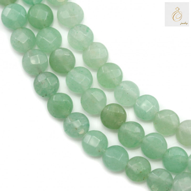 Green aventurine faceted flat round beads 6mm on strand - close-up view showing natural green color and brilliant faceted surface