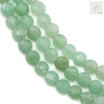 Green aventurine faceted flat round beads 6mm on strand - close-up view showing natural green color and brilliant faceted surface