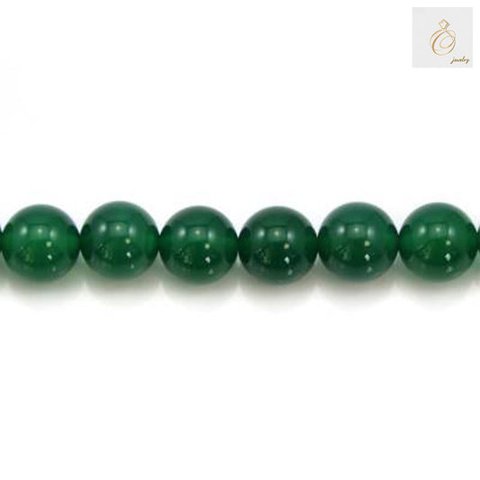Close-up view of polished green agate round beads