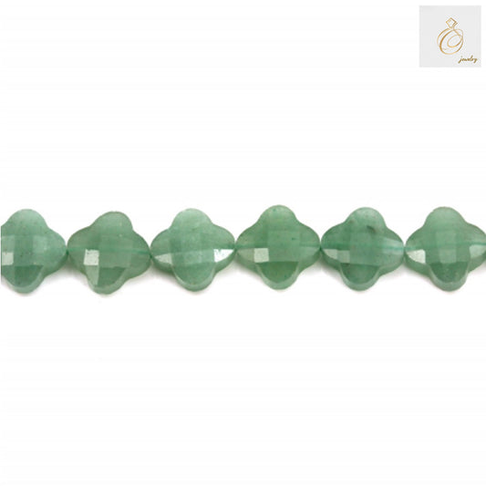 Close-up of green aventurine clover bead showing faceted surface and natural stone patterns