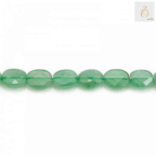 Close-up view of green aventurine oval beads displaying faceted surface and translucent green color