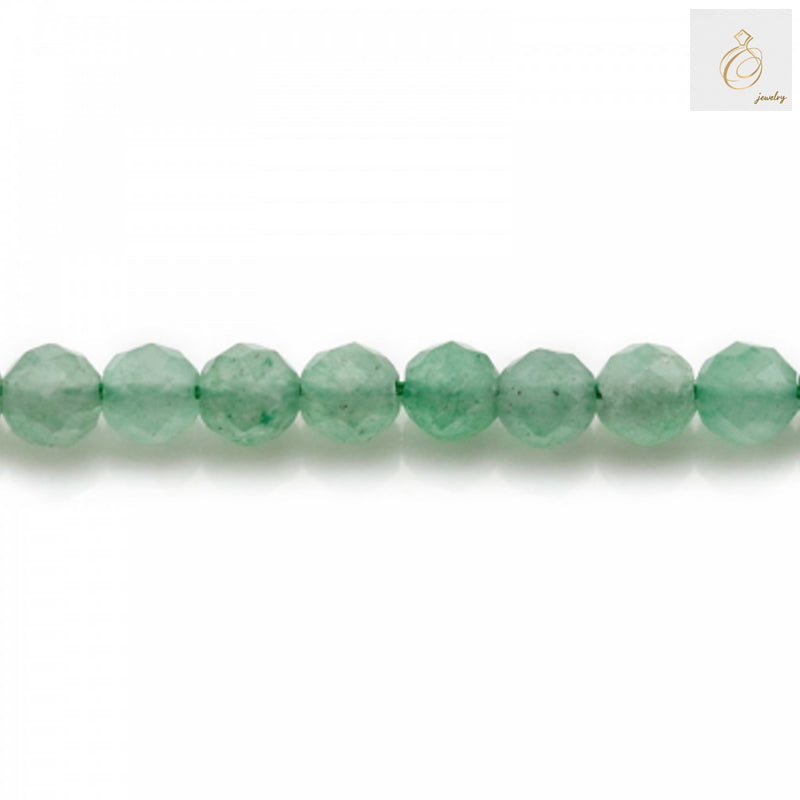 Close-up view of green aventurine 4mm faceted round beads displaying the natural stone texture and precision-cut facets that reflect light