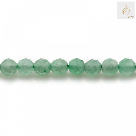Close-up view of green aventurine 4mm faceted round beads displaying the natural stone texture and precision-cut facets that reflect light