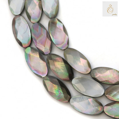 Close-up view of grey mother of pearl shell beads displaying faceted oval cut and natural grey coloring, jewelry making supplies