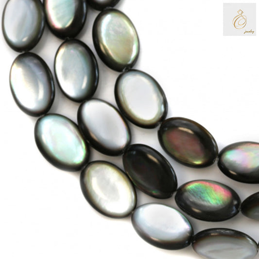 Close-up view of grey mother of pearl shell beads displaying the flat oval shape and natural iridescent texture