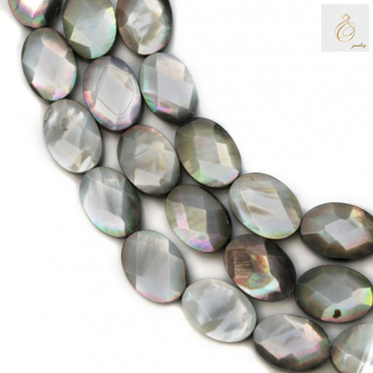 Close-up view of grey mother of pearl shell beads showing faceted oval surface and natural iridescent finish