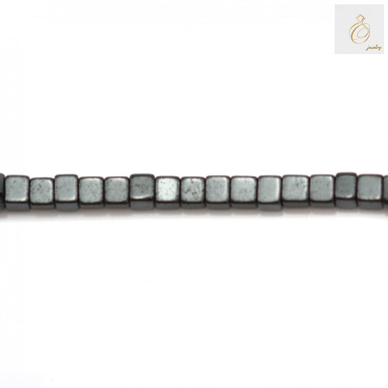 Close-up of 1mm hematite cube beads showing metallic luster and precise cubic cut shape