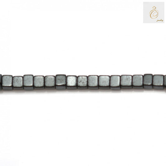 Close-up of 1mm hematite cube beads showing metallic luster and precise cubic cut shape